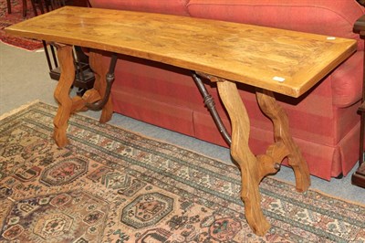 Lot 1388 - A Spanish parquetry top trestle table in the 17th century style, the bowed top raised on shaped...