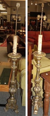 Lot 1390 - A pair of gilt wood twin-branch standard lamps of torchere form, each raised on three scroll...