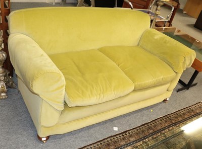 Lot 1391 - An early 20th century drop arm sofa upholstered in lime green velvet, 170cm by 80cm by 80cm