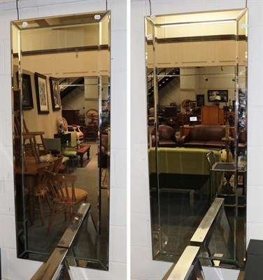 Lot 1399 - A pair of tall wall mirrors with bevelled borders, 60cm by 150cm