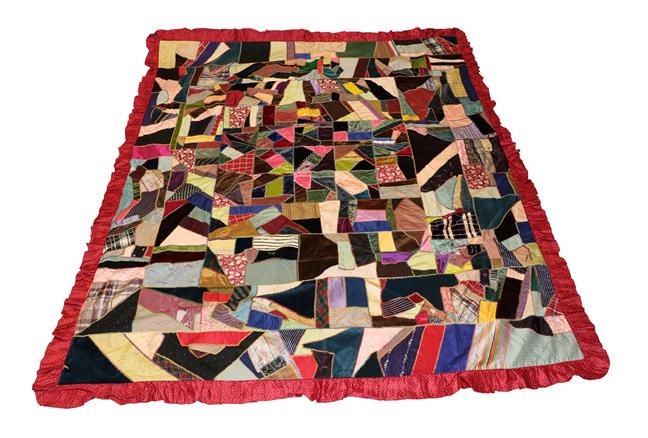 Lot 2011 - A Late 19th Century Crazy Patchwork Bed Cover, incorporating coloured velvets, silks, silk...