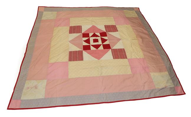 Lot 2014 - Victorian Patchwork Cover, incorporating a central red and white block, framed by a pink...