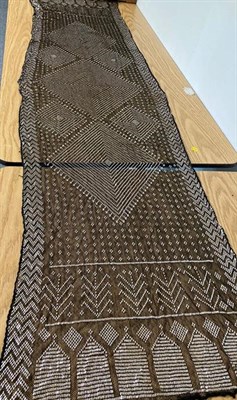 Lot 2038 - Circa 1920 Black Cotton Assuit Shawl, with geometric decoration size 73cm by 225cm; a Similar...