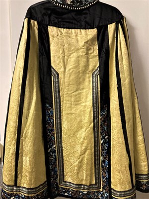 Lot 2049 - Early 20th Century Chinese Yellow Silk Brocade Cape with black silk shoulders, applied, embroidered