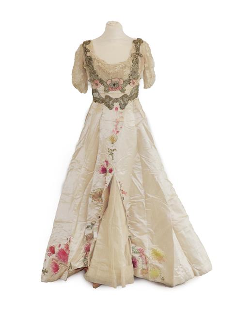 Lot 2053 - A Late 19th Century Ladies' Evening Dress, in cream silk with short net and lace pleated...
