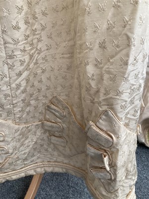 Lot 2054 - A19th Century Cream Silk Short Sleeve Dress woven with leaves, military style cream silk straps and