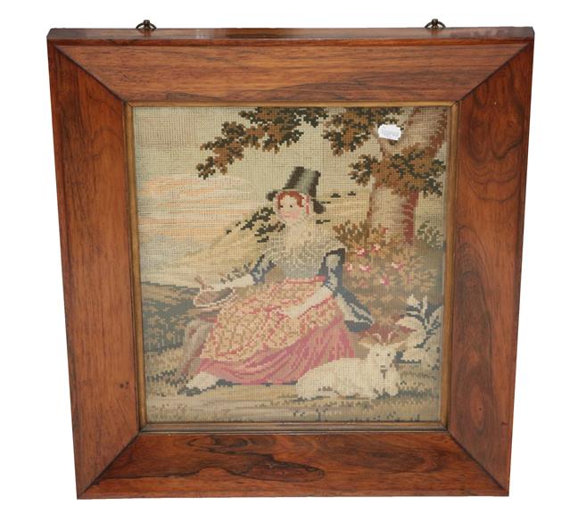 Lot 2058 - 19th Century Wool Work Picture of a Seated Lady in 'Welsh Costume', seated by a tree with a lamb to