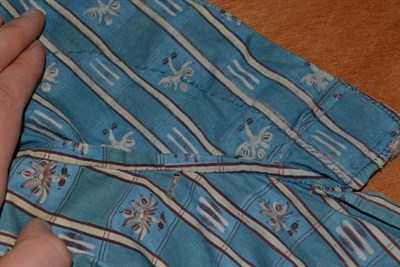 Lot 2065 - Early 19th Century Caraco, in a blue cotton printed with floral and ikat design in alternating...
