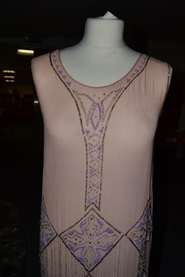 Lot 2074 - Circa 1920sPale Pink Crepe Sleeveless Flapper Dress, with scooped neckline, appliquéd with...