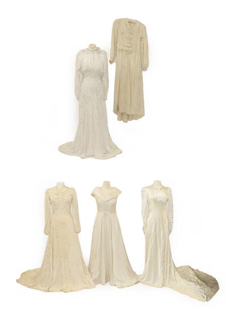 Lot 2078 - Circa 1940 and Later Wedding Dresses, comprising a cream brocade dress with a train, multi...