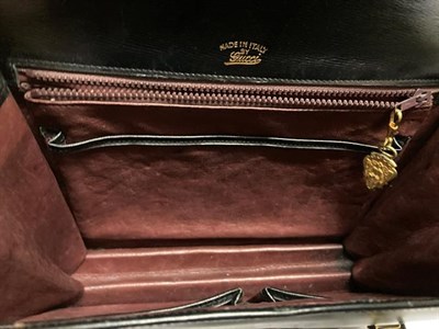 Lot 2143 - Gucci Black Leather and Patent Handbag, with gilt metal clasp to the front and shaped flap,...