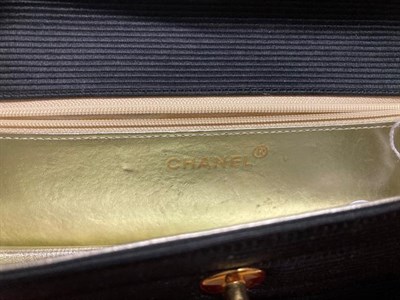 Lot 2144 - Chanel Black Fabric Ribbed Clutch Bag, gold tone hardware, gold/silver leather  lining,...