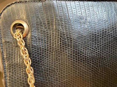 Lot 2145 - A Circa 1960 Cartier Black Leather Handbag, with 9ct gold circular apertures to the top and...