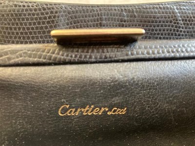 Lot 2145 - A Circa 1960 Cartier Black Leather Handbag, with 9ct gold circular apertures to the top and...