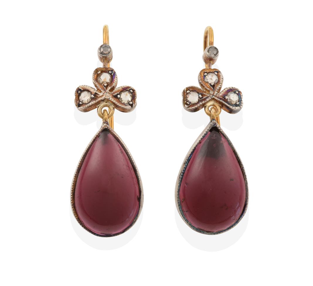 Lot 2003 - A Pair of Garnet and Diamond Drop Earrings, a single rose cut diamond above a trefoil cluster...