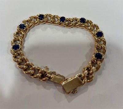 Lot 2005 - A Sapphire Bracelet, the yellow curb link bracelet with seven oval cut sapphires spaced evenly...