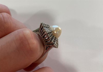Lot 2007 - A Pearl and Diamond Cluster Ring, the central button pearl within an undulating border of eight-cut
