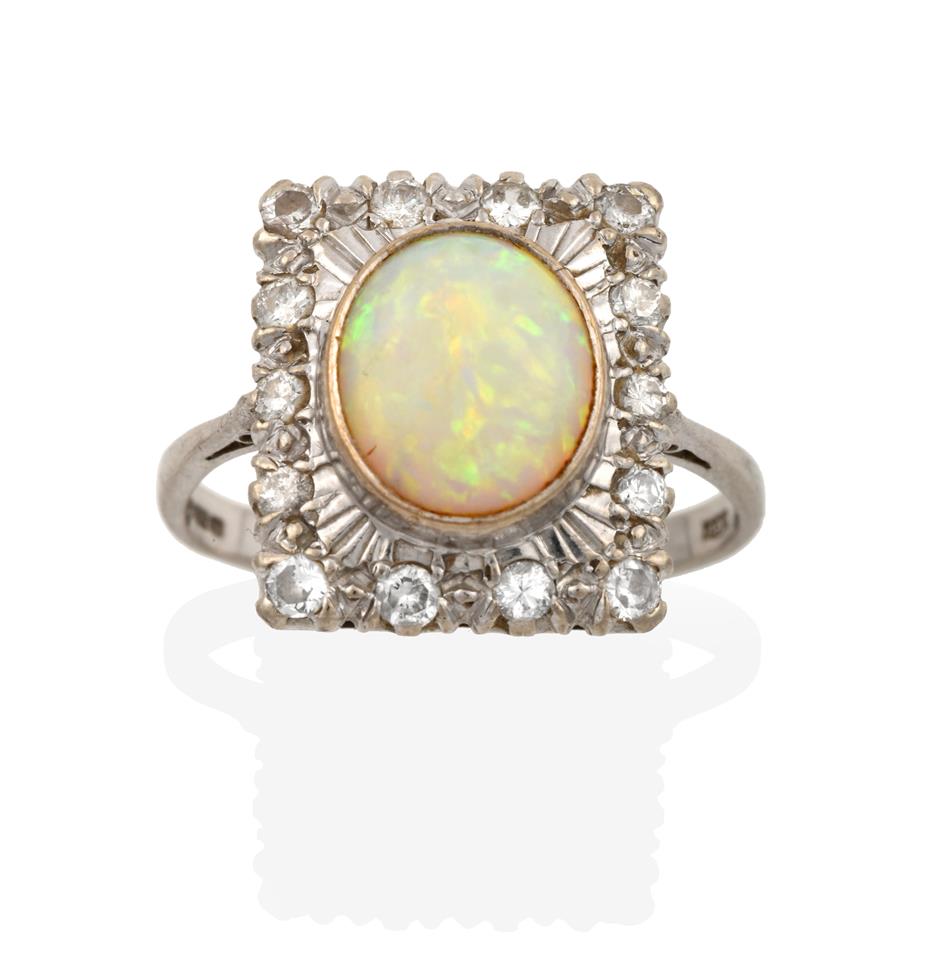 Lot 2008 - An 18 Carat White Gold Opal and Diamond Cluster Ring, the plaque set throughout with eight-cut...