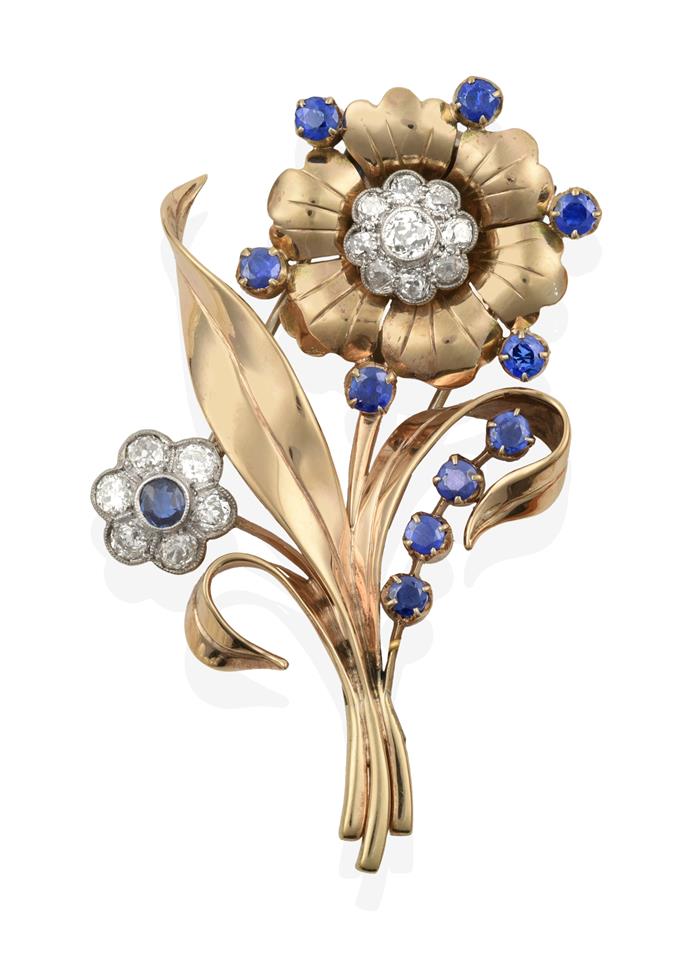 Lot 2009 - A Sapphire and Diamond Floral Brooch, circa 1940s, one flower formed of a round cut sapphire within