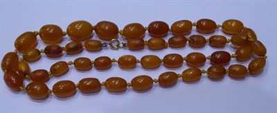 Lot 2012 - Two Amber Bead Necklaces, formed of forty-one and forty-four graduated amber beads, lengths...