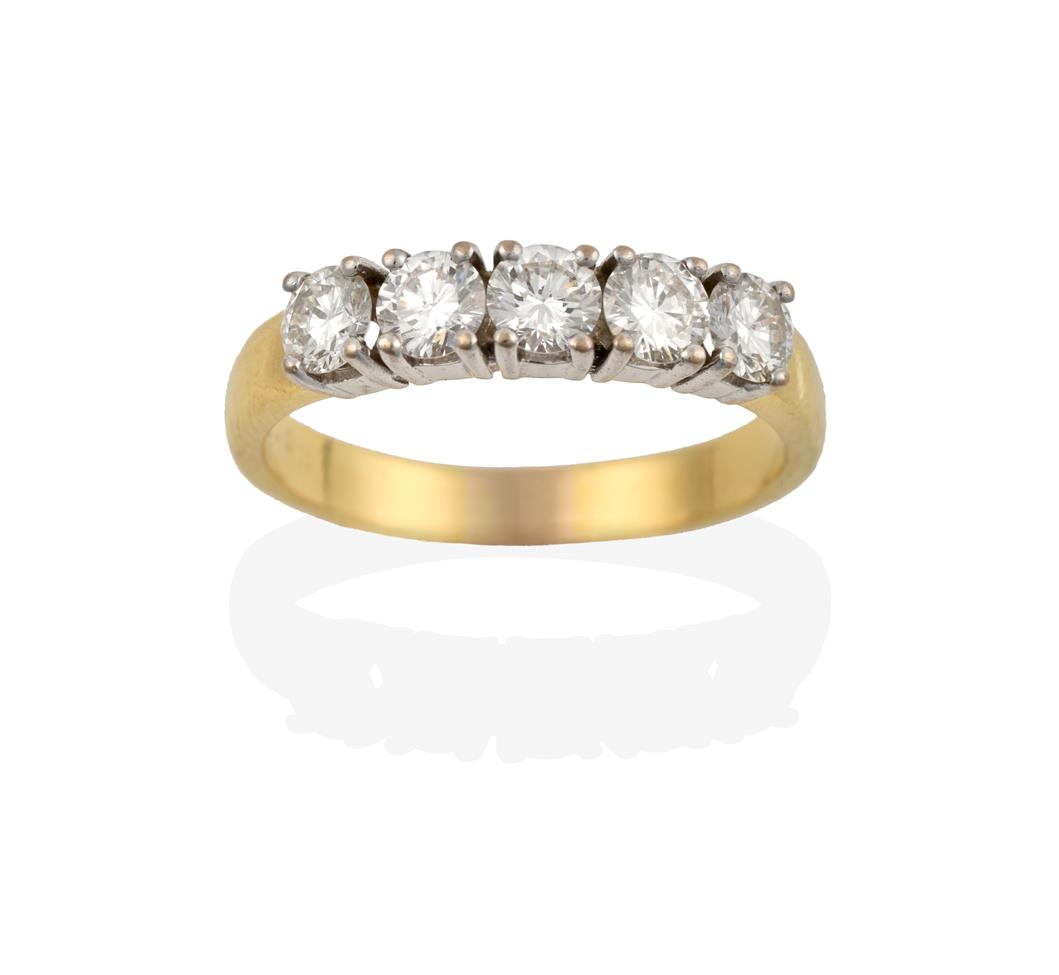 Lot 2023 - An 18 Carat Gold Diamond Five Stone Ring, the round brilliant cut diamonds in white claw...