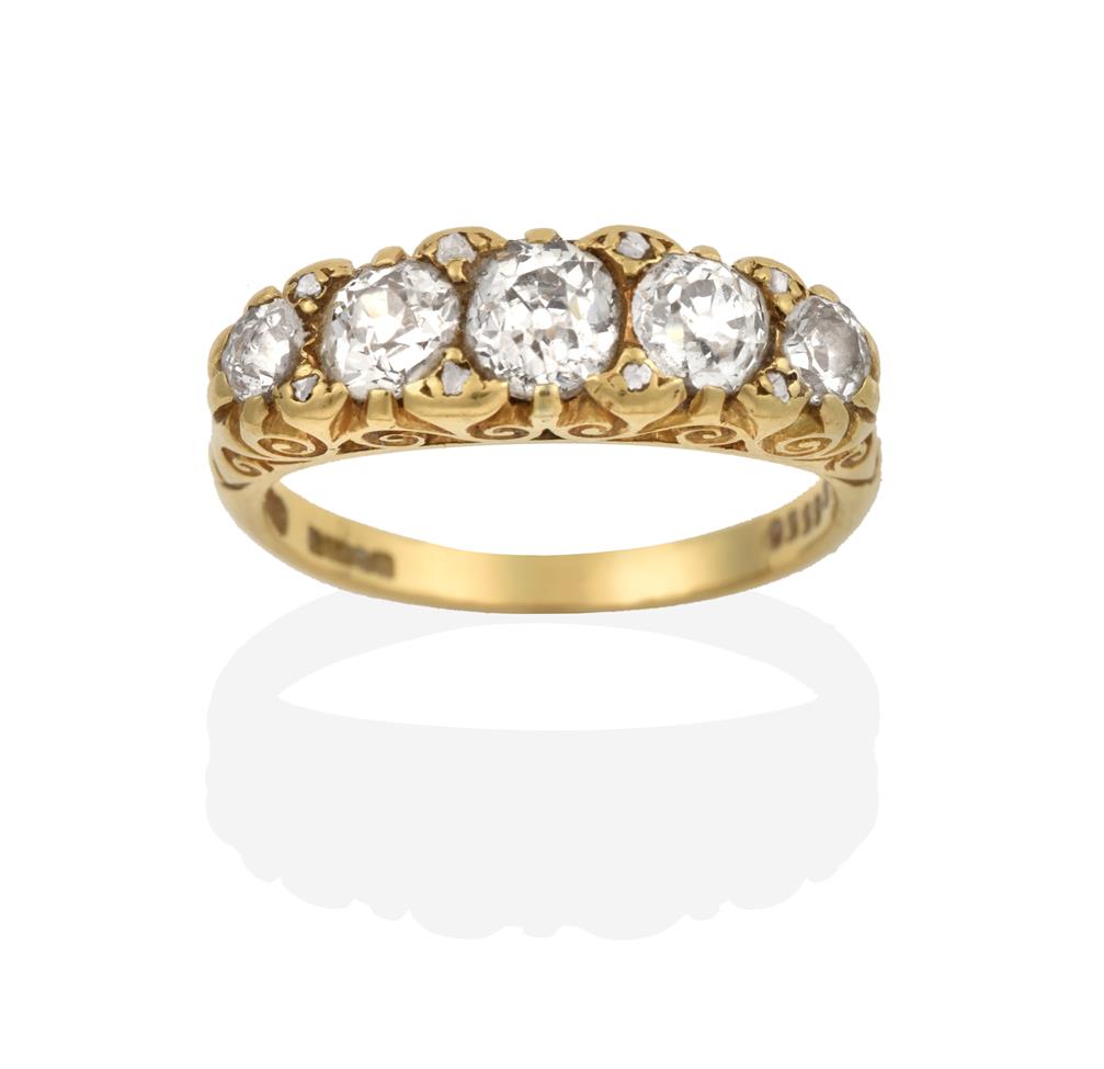 Lot 2024 - An 18 Carat Gold Diamond Five Stone Ring, the graduated old cut diamonds with rose cut diamond...
