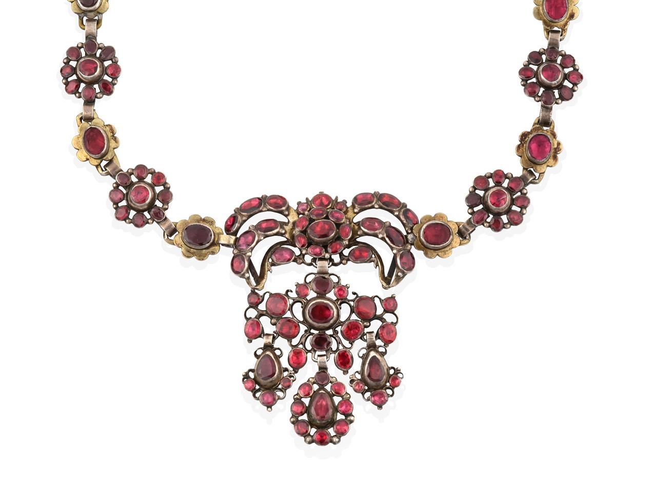Lot 2025 - A Garnet and Red Stone Necklace, the central panel formed of a bow motif suspends a scroll motif to