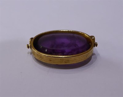 Lot 2029 - An Amethyst Intaglio Swivel Fob, the oval amethyst depicting a figure subject with Roman...