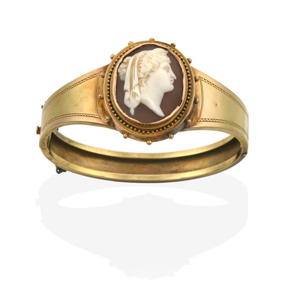 Lot 2032 - A Victorian Cameo Bangle, the oval cameo depicting a lady in profile, within a yellow ropetwist and