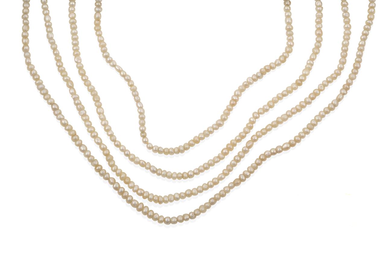 Lot 2037 - A Seed Pearl Necklace, the four rows of seed pearls knotted to a torpedo shaped clasp set...