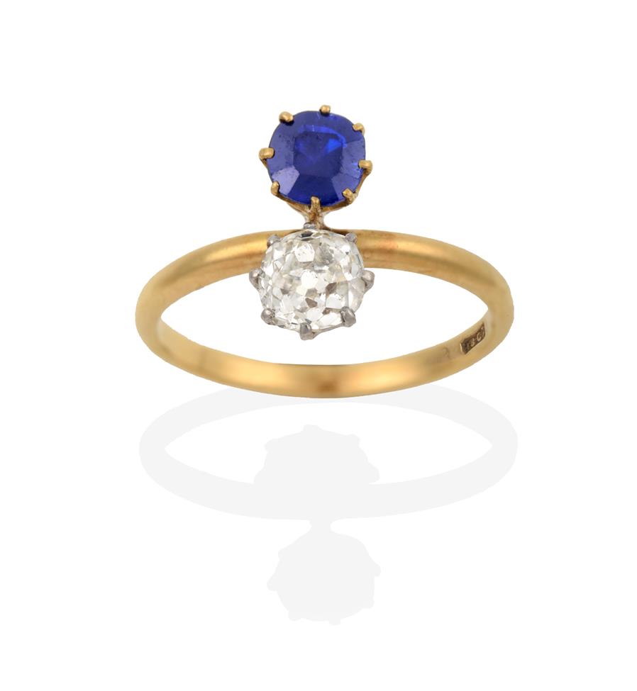 Lot 2041 - A Sapphire and Diamond Two Stone Ring, the old cut diamond in white claw settings and the...