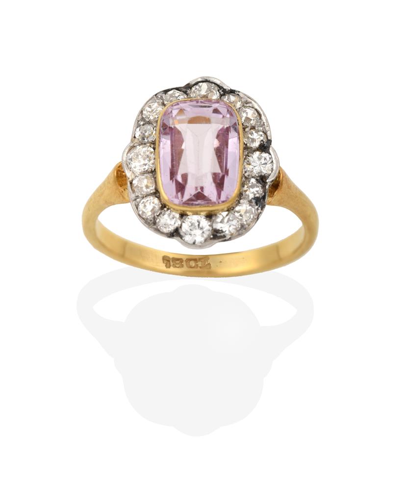 Lot 2044 - A Pink Tourmaline and Diamond Cluster Ring, the cushion cut pink tourmaline in a yellow rubbed over