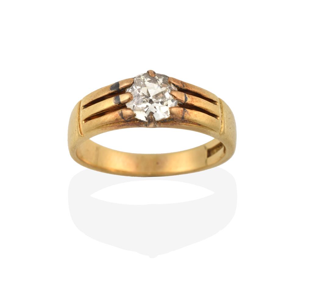 Lot 2048 - A Diamond Solitaire Ring, the old cut diamond in a yellow claw setting, to a grooved shoulder plain