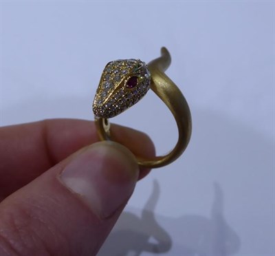 Lot 2049 - A Ruby and Diamond Snake Ring, the head pavé set with round brilliant cut diamonds and round...