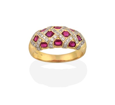 Lot 2055 - An 18 Carat Gold Synthetic Ruby and Diamond Ring, the domed top inset with oval cut synthetic...