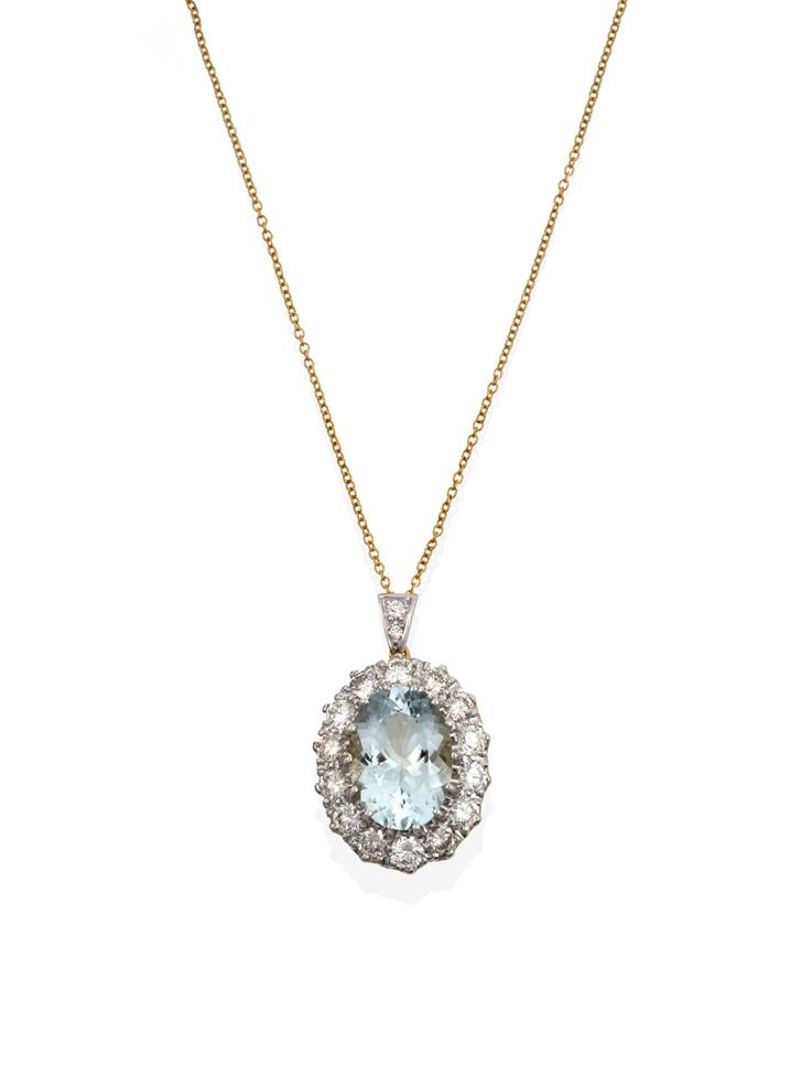 Lot 2056 - An Aquamarine and Diamond Cluster Pendant on Chain, the oval cut aquamarine within a border of...