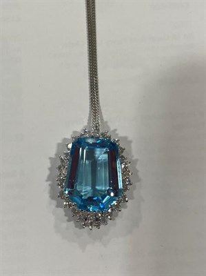 Lot 2057 - An Aquamarine and Diamond Cluster Pendant on Chain, the fancy cut aquamarine within a border of...