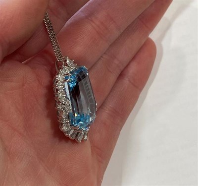 Lot 2057 - An Aquamarine and Diamond Cluster Pendant on Chain, the fancy cut aquamarine within a border of...
