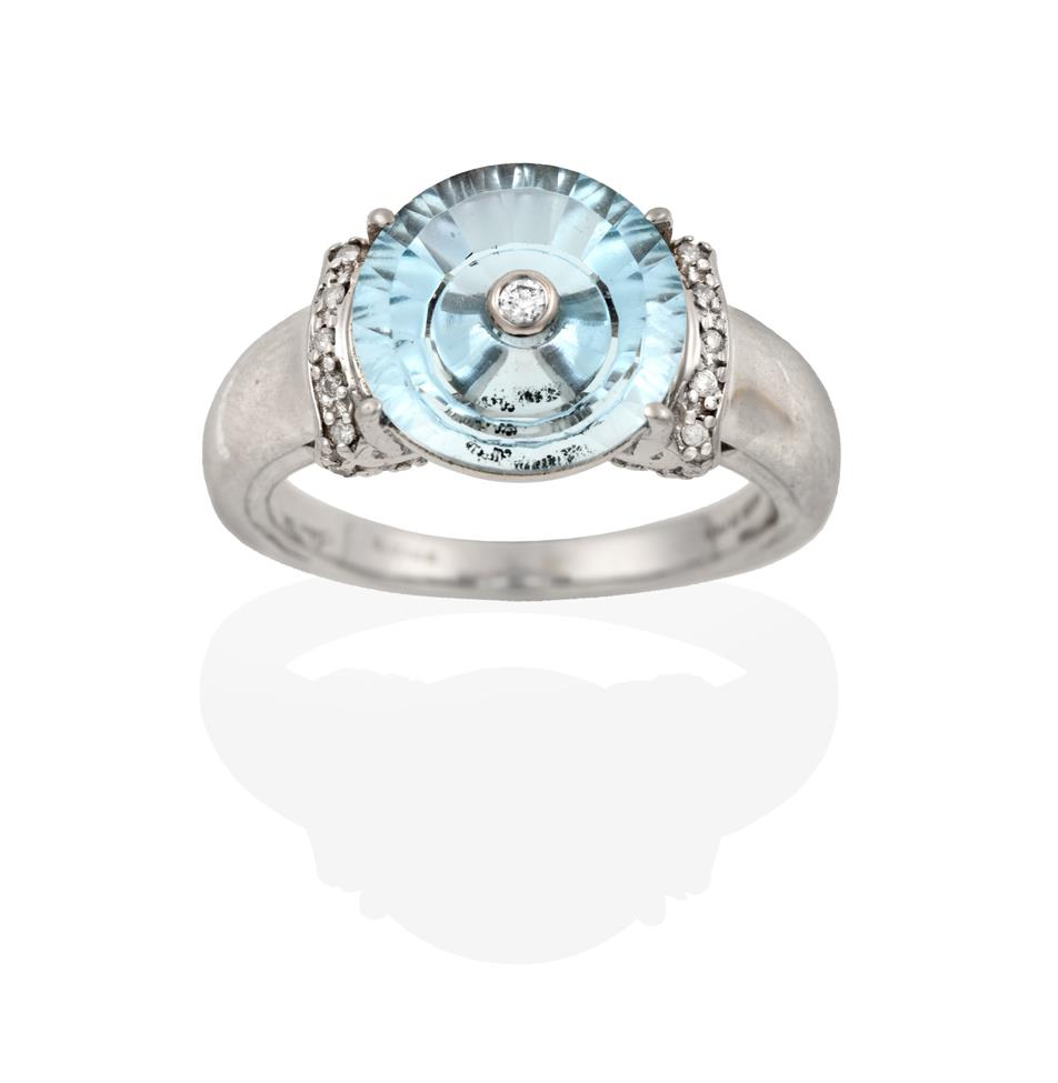 Lot 2059 - A 9 Carat White Gold Blue Topaz and Diamond Ring, the fancy cut blue topaz with an eight-cut...
