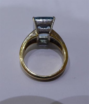 Lot 2062 - An 18 Carat Gold Aquamarine and Diamond Ring, the emerald-cut aquamarine in a white four claw...