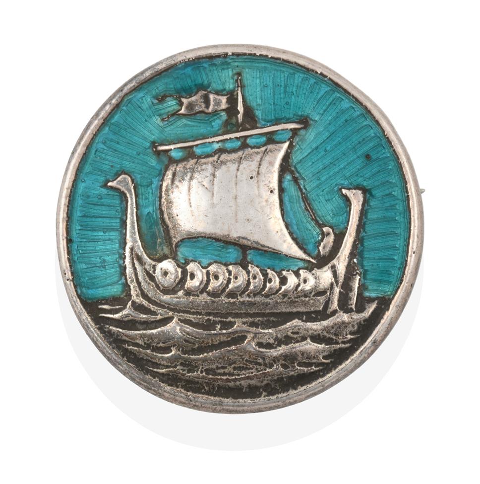 Lot 2069 - An Enamel Iona brooch, by Alexander Ritchie, the circular plaque depicting a Viking ship and...