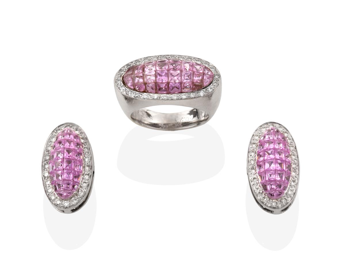 Lot 2071 - A Pink Sapphire and Diamond Ring, the central domed plaque formed of calibré cut pink...