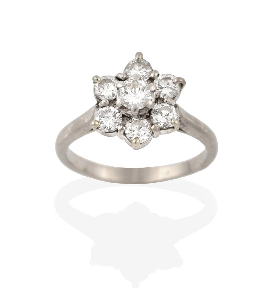 Lot 2074 - A Diamond Cluster Ring, the raised central round brilliant cut diamond within a border of round...