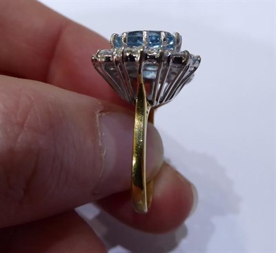 Lot 2077 - An 18 Carat Gold Aquamarine and Diamond Triple Cluster Ring, three oval cut aquamarines within...