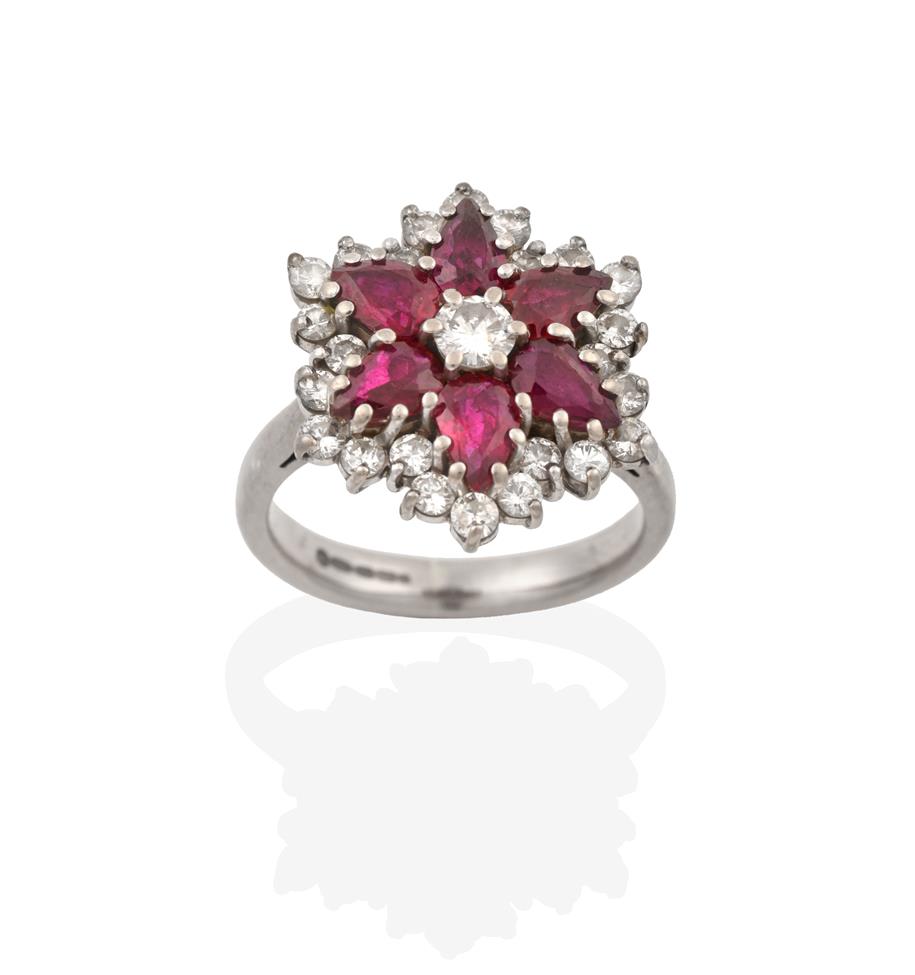 Lot 2086 - An 18 Carat White Gold Ruby and Diamond Cluster Ring, the central round brilliant cut diamond...