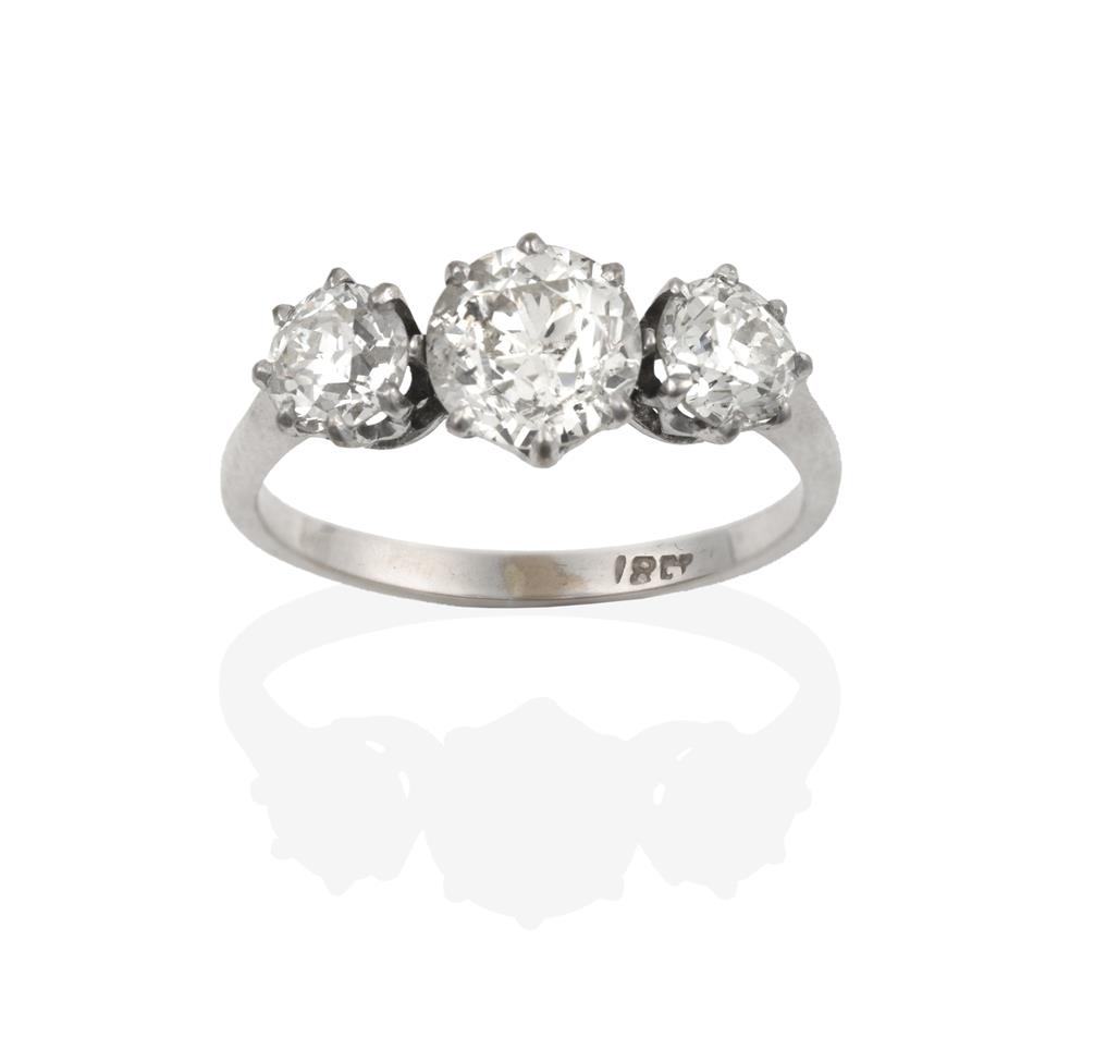 Lot 2090 - A Diamond Three Stone Ring, the graduated old cut diamonds in white claw settings, to a tapered...