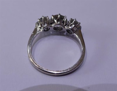 Lot 2090 - A Diamond Three Stone Ring, the graduated old cut diamonds in white claw settings, to a tapered...