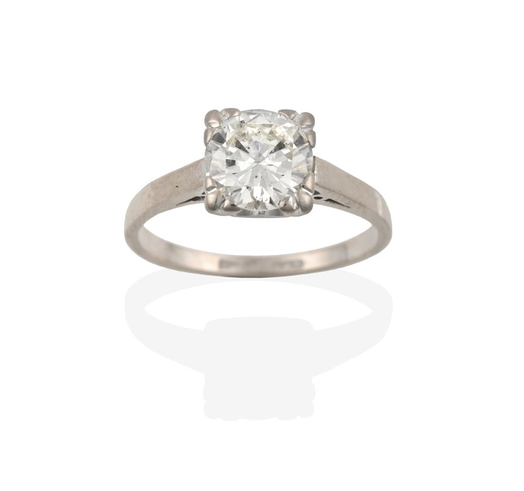 Lot 2094 - A Diamond Solitaire Ring, the round brilliant cut diamond in a white four claw setting, to a...