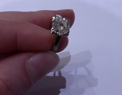 Lot 2094 - A Diamond Solitaire Ring, the round brilliant cut diamond in a white four claw setting, to a...