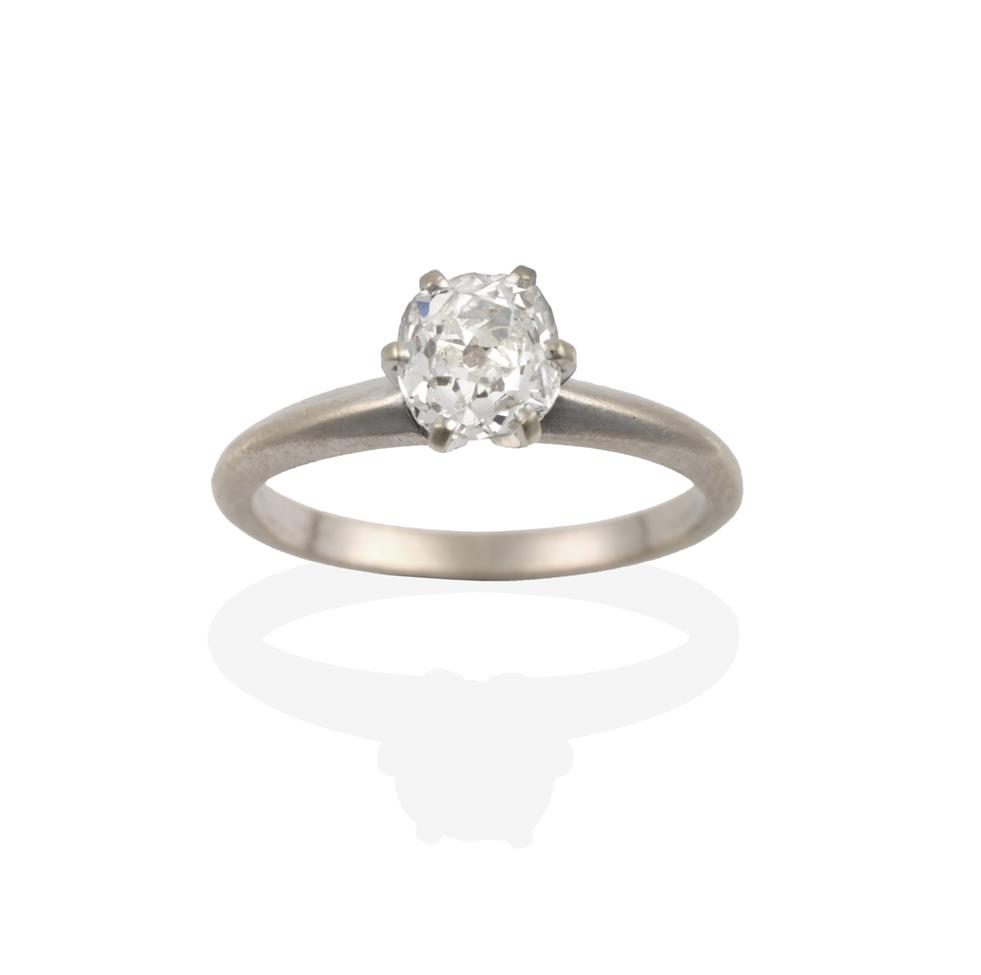 Lot 2095 - An 18 Carat White Gold Diamond Solitaire Ring, the old cut diamond in a claw setting, to a...